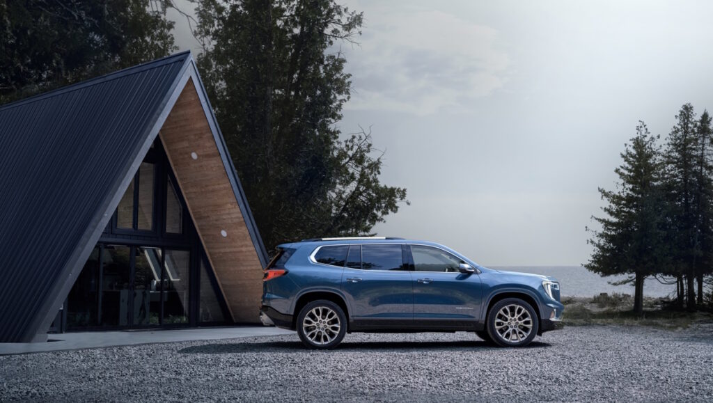 Wide angle side profile of the 2024 GMC Acadia Denali.
