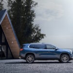 Wide angle side profile of the 2024 GMC Acadia Denali.